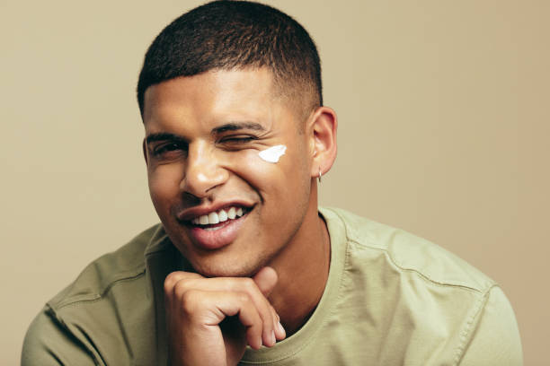 istock Fun skincare routine: Handsome young man smiles with beauty cream on his face 1493460623