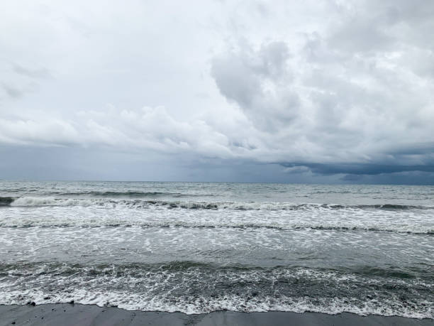 istock waves of the beach, overcast. 1493461300
