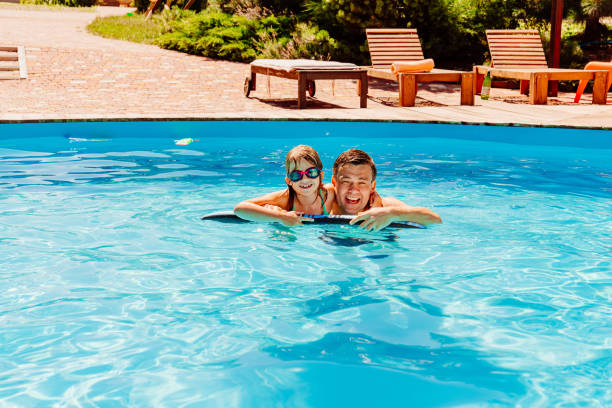 istock Dad and daughter have fun and swim in the pool. 1493463218