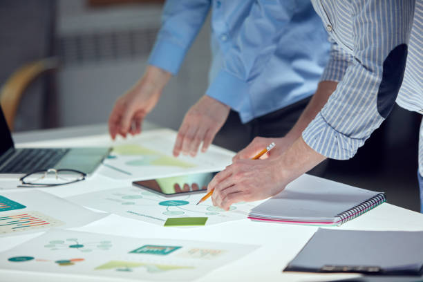 istock Team of entrepreneurs are brainstorming ideas on notes over table with documents. Agile methodology, sprint planning, story mapping, product backlog 1493465735