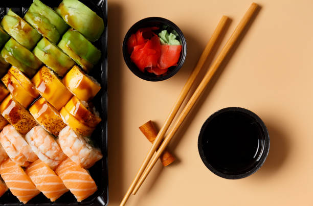 istock Set of sushi rolls in plastic packages on a light background, top view. 1493466446
