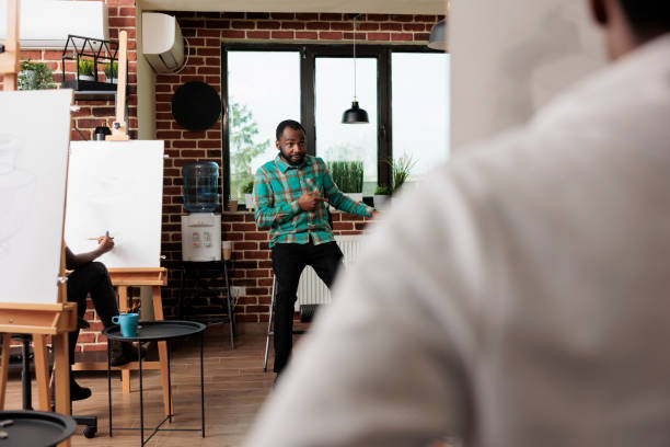 istock Art teacher during adult drawing lesson 1493469615