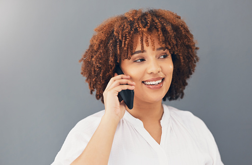 Phone call, happy and smile with black woman in studio background for communication, contact and internet. Networking, technology and mobile with girl talking for online, discussion and news