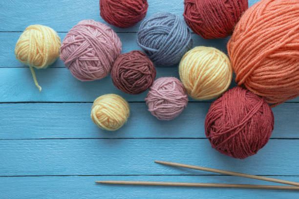 istock Hobbies and knitting concept. Balls of wool and  knitting needles on  rustic table. Copy space 1493472650
