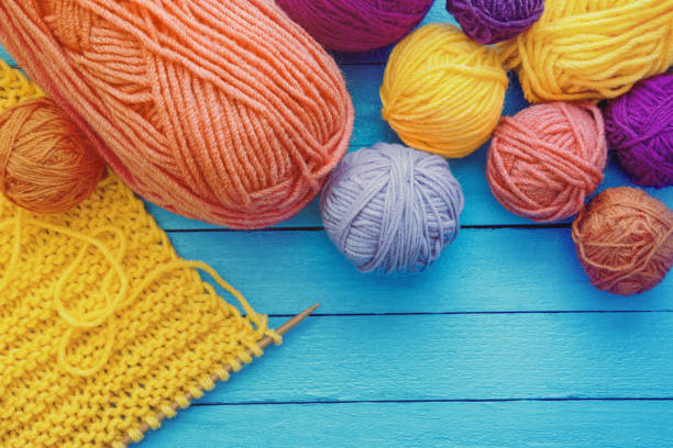 istock Hobbies and knitting concept. Colorful balls of wool on blue rustic table. Copy space 1493472671