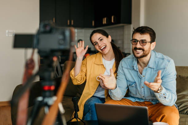 istock A cheerful couple of vloggers recording a video tutorial session of trading. Making tutorials on the stock exchange, home investment, and financial trading. 1493474684