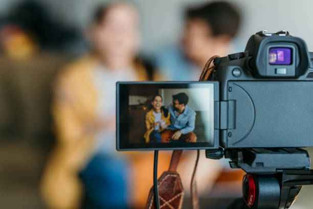 istock A cheerful couple of vloggers recording a video tutorial session of trading. Making tutorials on the stock exchange, home investment, and financial trading. 1493474733