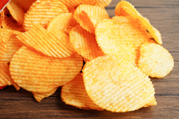 istock Potato chips in open bag, delicious BBQ seasoning spicy for crips, thin slice deep fried snack fast food. 1493478033