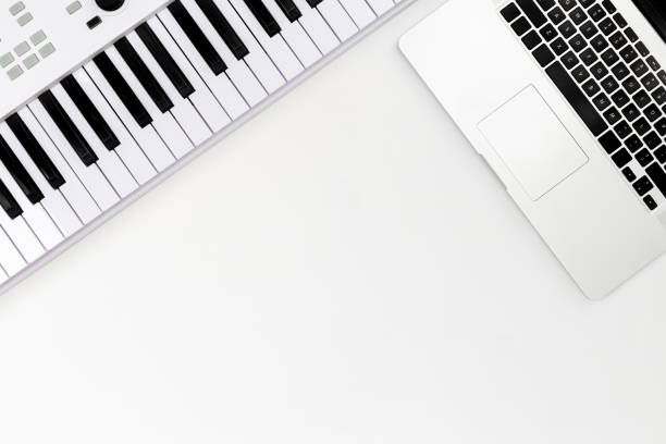 istock Musical keys and a laptop on a white background, top view, minimalism. 1493478227