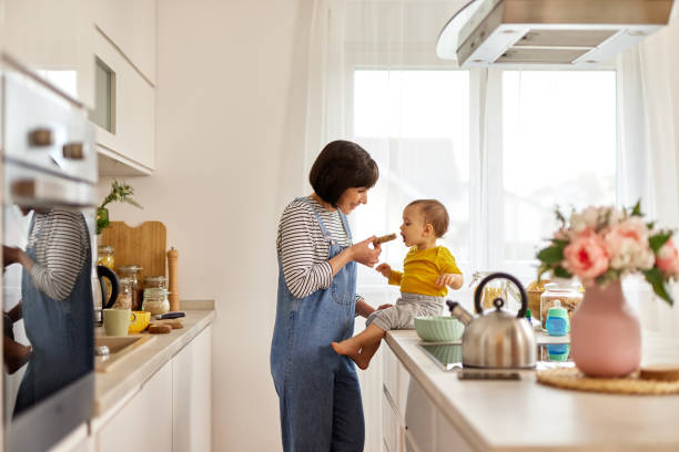 istock Mother feeding baby boy in the kitchen 1493478971