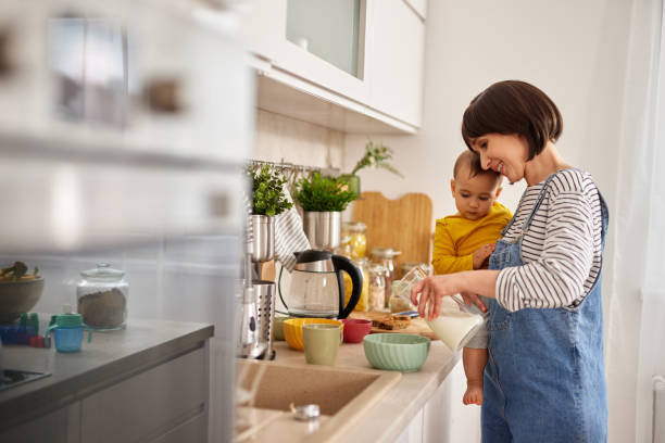 istock Mother and baby boy in the kitchen preparing breakfast 1493479088