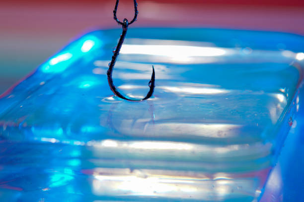 Fishing hook on a dark background. Close-up. Selective focus.