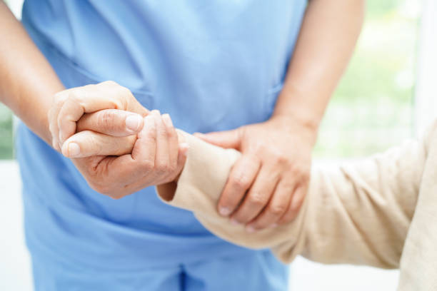 istock Doctor holding hands Asian elderly woman patient, help and care in hospital. 1493480098