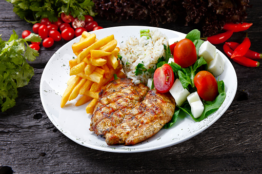 grilled chicken steak with potatoes and rice, salad