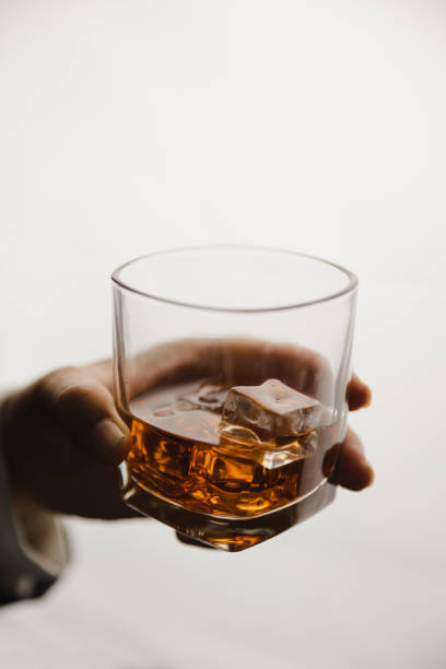 istock Young man holding whiskey glass in bar or restaurant. 1493485688