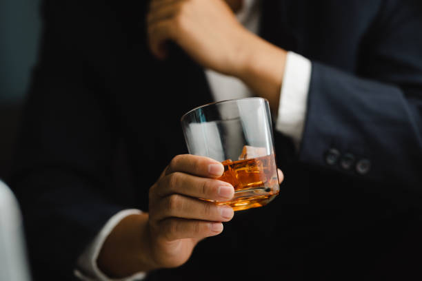 istock Young man holding whiskey glass in bar or restaurant. 1493485742