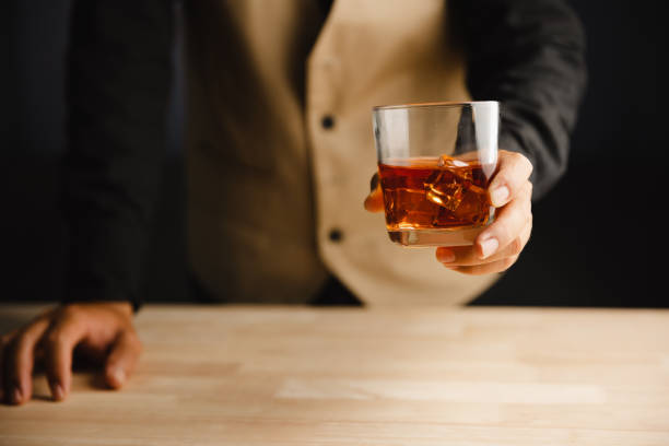 istock Young man holding whiskey glass in bar or restaurant. 1493485804