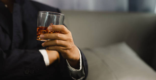 istock Young man holding whiskey glass in bar or restaurant. 1493485896
