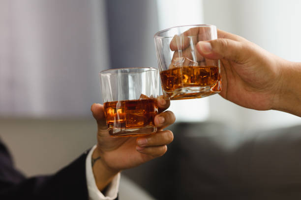 istock Young man holding whiskey glass in bar or restaurant. 1493485914