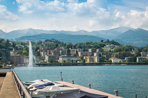 Lugano city and Lugano lake in a beautiful summer day. Lugano city is located on a big Swiss lake in the Canton Ticino and is an important tourist route in southern Switzerland
