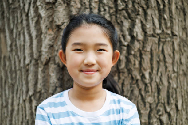 Little girl on bark background
