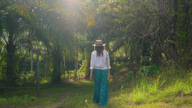 Cheerful woman walking in the jungles on sunny day