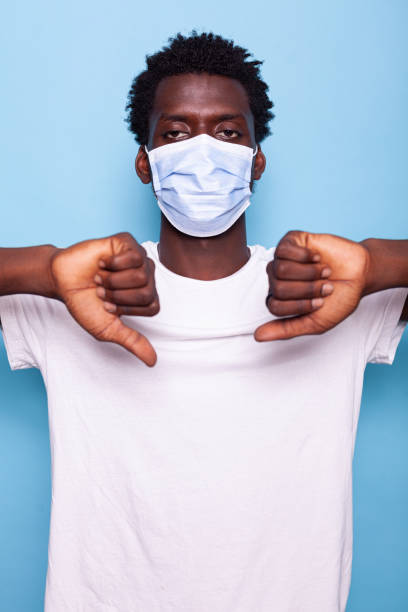 istock Young adult showing thumbs down gesture with hands 1493497322