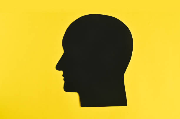 Male profile head on yellow background