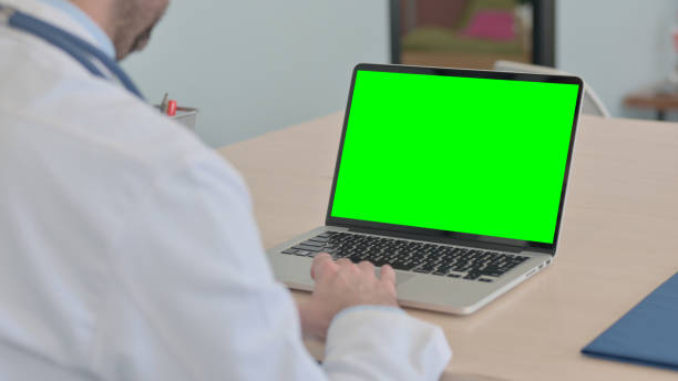istock Close Up of Doctor Using Laptop with Green Screen 1493506364