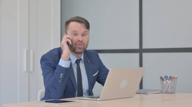 istock Upset Businessman Arguing on Phone Talk 1493507294