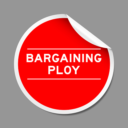 Red color peel sticker label with word bargaining ploy on gray background