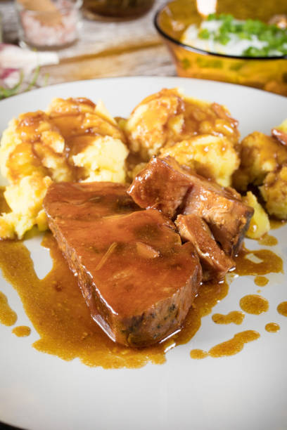 istock Braised pork neck in own sauce served with boiled potatoes. 1493514376