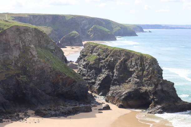 istock Bedruthan Steps, Cornwall, at low tide in sunshine against a clear blue sky 1493515440