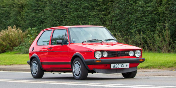 Bicester, Oxon, UK, October 10th 2021.  1983 RED VOLKSWAGEN GOLF GTI   classic car travelling on an English country road