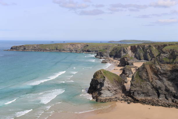 istock Bedruthan Steps, Cornwall, at low tide in sunshine against a clear blue sky 1493515577