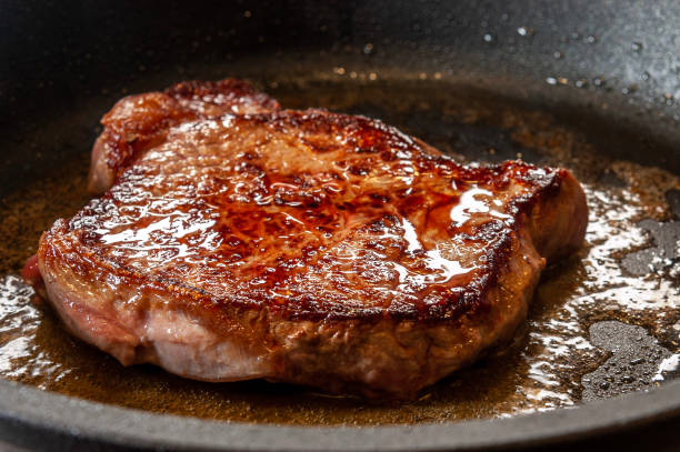 istock Raw prime rib in pan with melted butter 1493516029