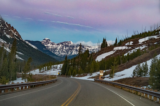 Highway scene approaching Cooke City, Montana from the east at dawn in the Yellowstone Ecosystem in western USA, North America. Nearest cities are Gardiner, Cooke City, Bozeman, Billings, Montana, Jackson, Wyoming, Salt Lake City, Utah and Denver, Colorado.