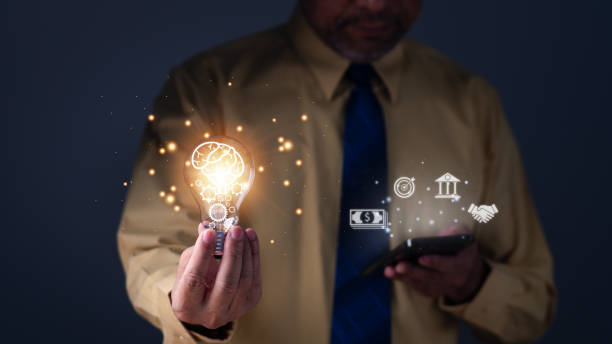 istock Hand of a man holding illuminated light bulb, concept creativity with bulbs that shine glitter. Inspiration of ideas for sustainable business development. an Idea of innovation and inspiration concept 1493518820