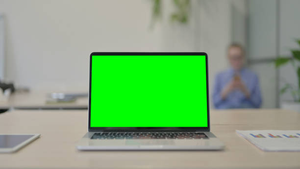 istock Laptop with Green Screen on Desk in Office 1493520598