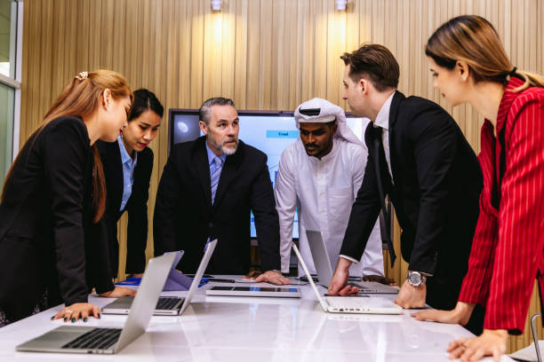 istock Diverse colleagues gather in brainstorm discuss statistics together. 1493521404