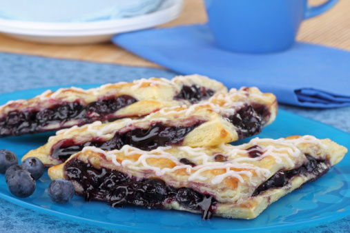 Blueberry turnovers with berries on a platter