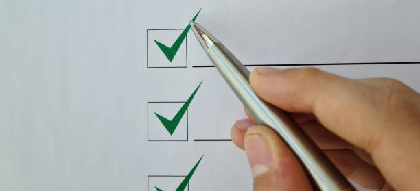 istock Silver ballpoint pen to cross off items from checklist 1493526532