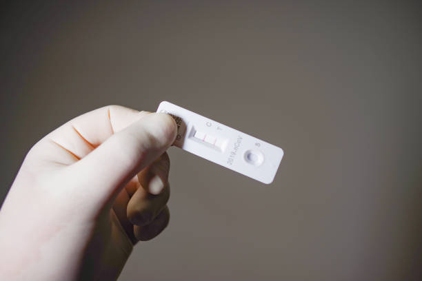 istock Rapid Antigen Test kit with Positive result during swab COVID-19 testing 1493526946