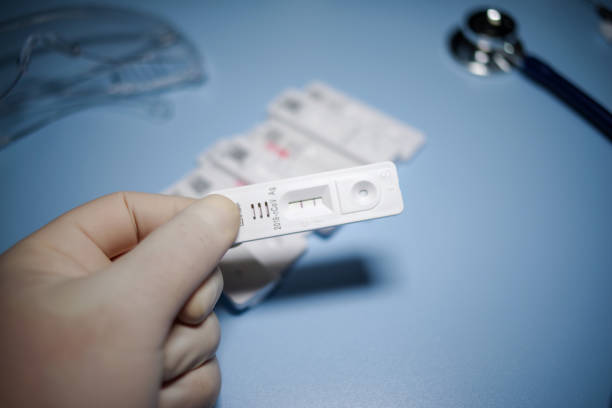 istock Rapid Antigen Test kit with Positive result during swab COVID-19 testing 1493526980