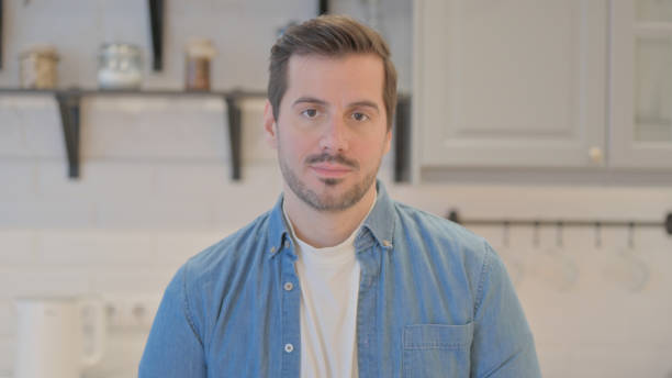 istock Portrait of Serious Young Man Looking at Camera 1493529753