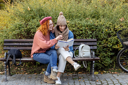 Millennial women exercising in the city park on the overcast morning in the fall.