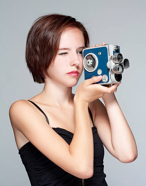 istock girl with film camera 149353209