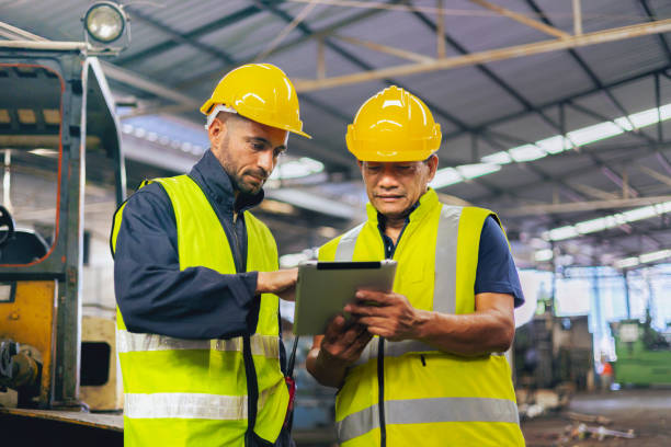 istock two engineer look projects and planning with tablet mobile in factory 1493532769