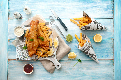 Traditional fish and chips takeout wrapped in newspaper