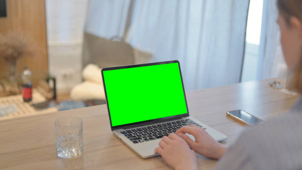 istock Young Woman Using Laptop with Green Screen 1493537479